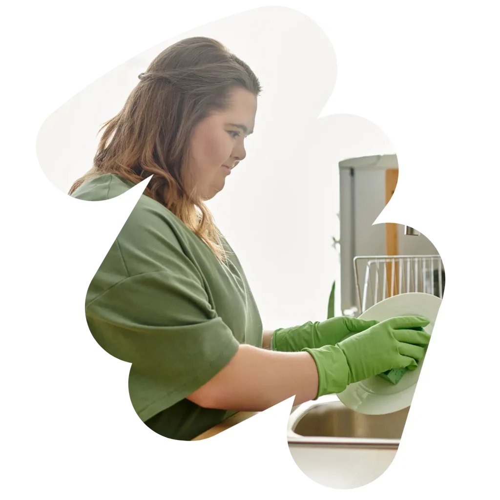 Disabled girl with down syndrome doing the dishes